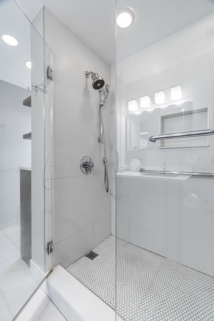 21 West Chestnut Street, Unit 1403 Chicago, IL 60654 - Photo 13 of 19 a bathroom with a sink a toilet and shower