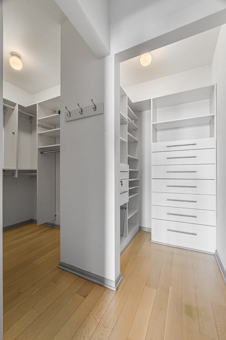 21 West Chestnut Street, Unit 1403 Chicago, IL 60654 - Photo 9 of 19 a view of walk in closet with empty racks