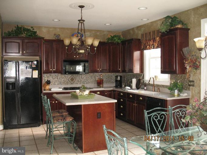 4721 East Basford Road Frederick, MD 21703 - Photo 15 of 28 a kitchen with stainless steel appliances granite countertop a sink stove and refrigerator