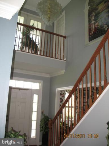 4721 East Basford Road Frederick, MD 21703 - Photo 5 of 28 a view of staircase with lots of frames on wall and a window