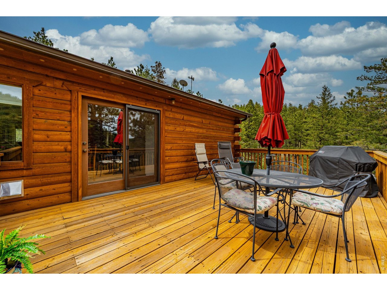 310 Wendelyn Way Boulder, CO 80302 - Photo 16 of 40 a view of a roof deck with table and chairs a barbeque with wooden floor