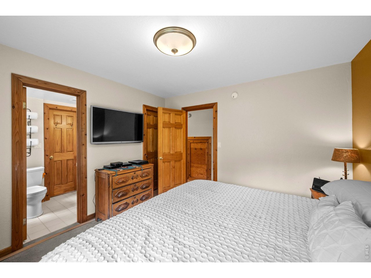 310 Wendelyn Way Boulder, CO 80302 - Photo 24 of 40 a bedroom with a bed and a flat screen tv