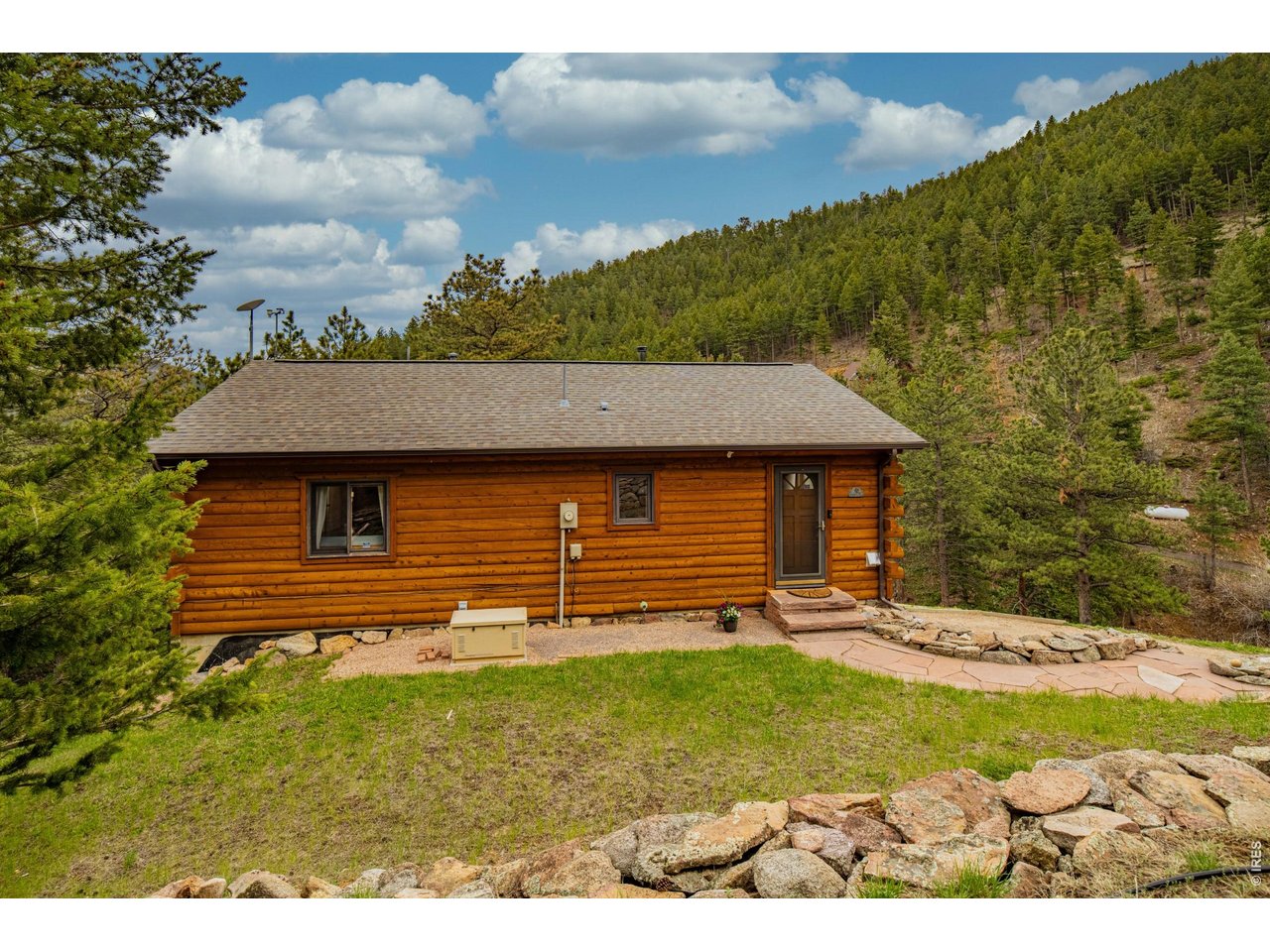 310 Wendelyn Way Boulder, CO 80302 - Photo 32 of 40 a backyard of a house with a yard and outdoor seating