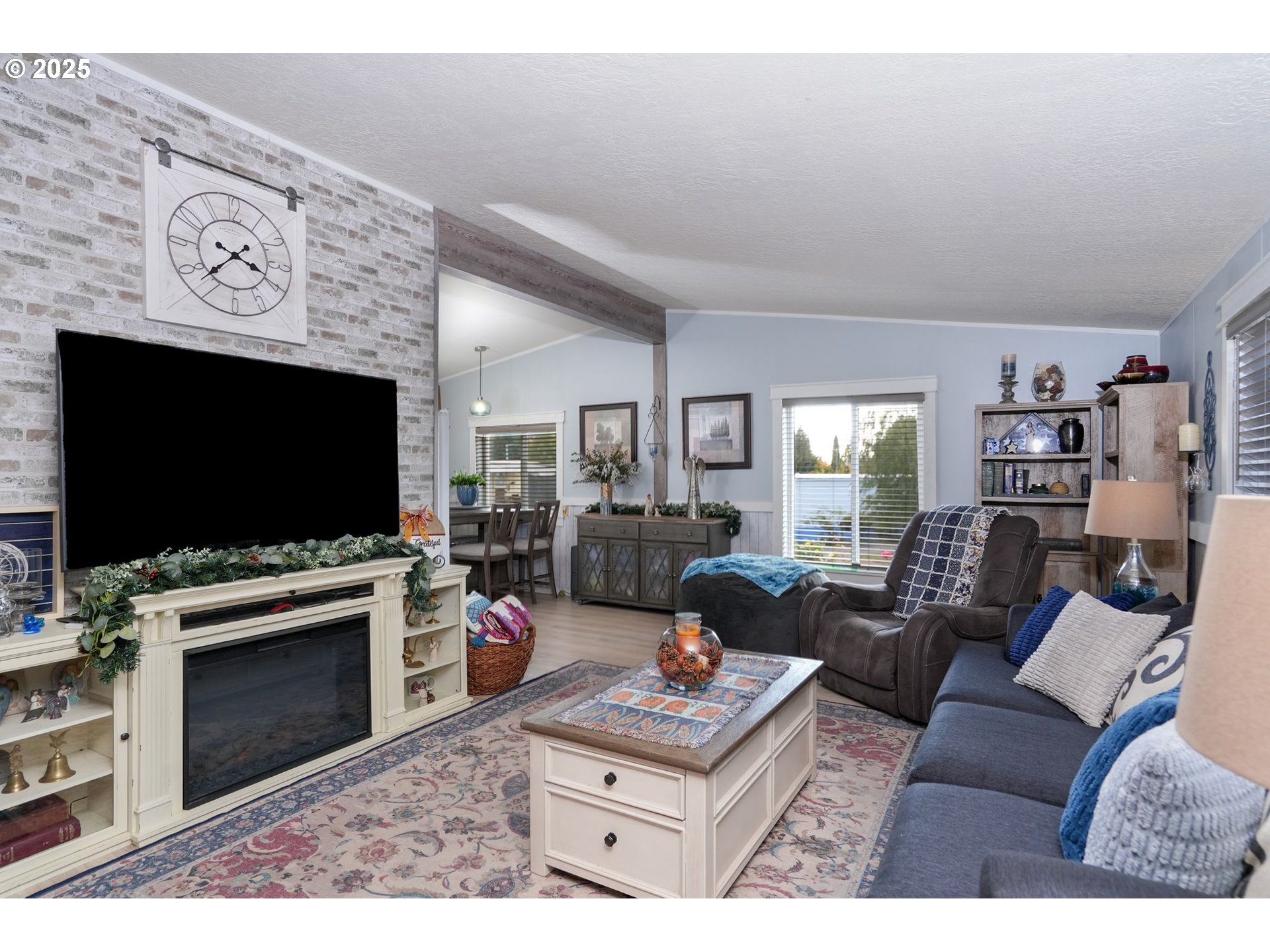 340 Northeast Crest Street, Unit 71 Sublimity, OR 97385 - Photo 11 of 33 a living room with furniture and a flat screen tv