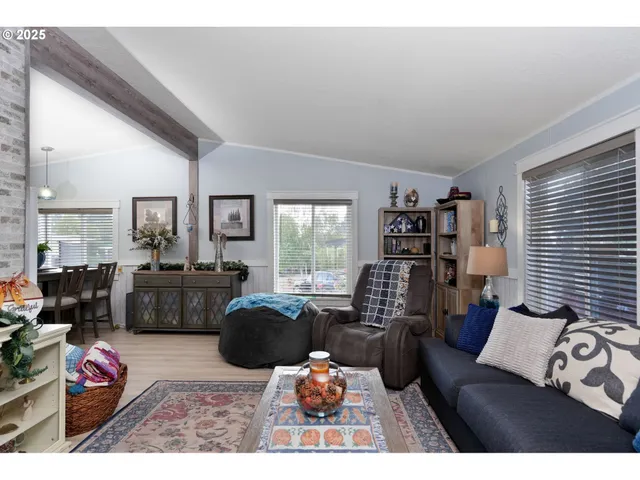 a living room with furniture large window and flat screen tv