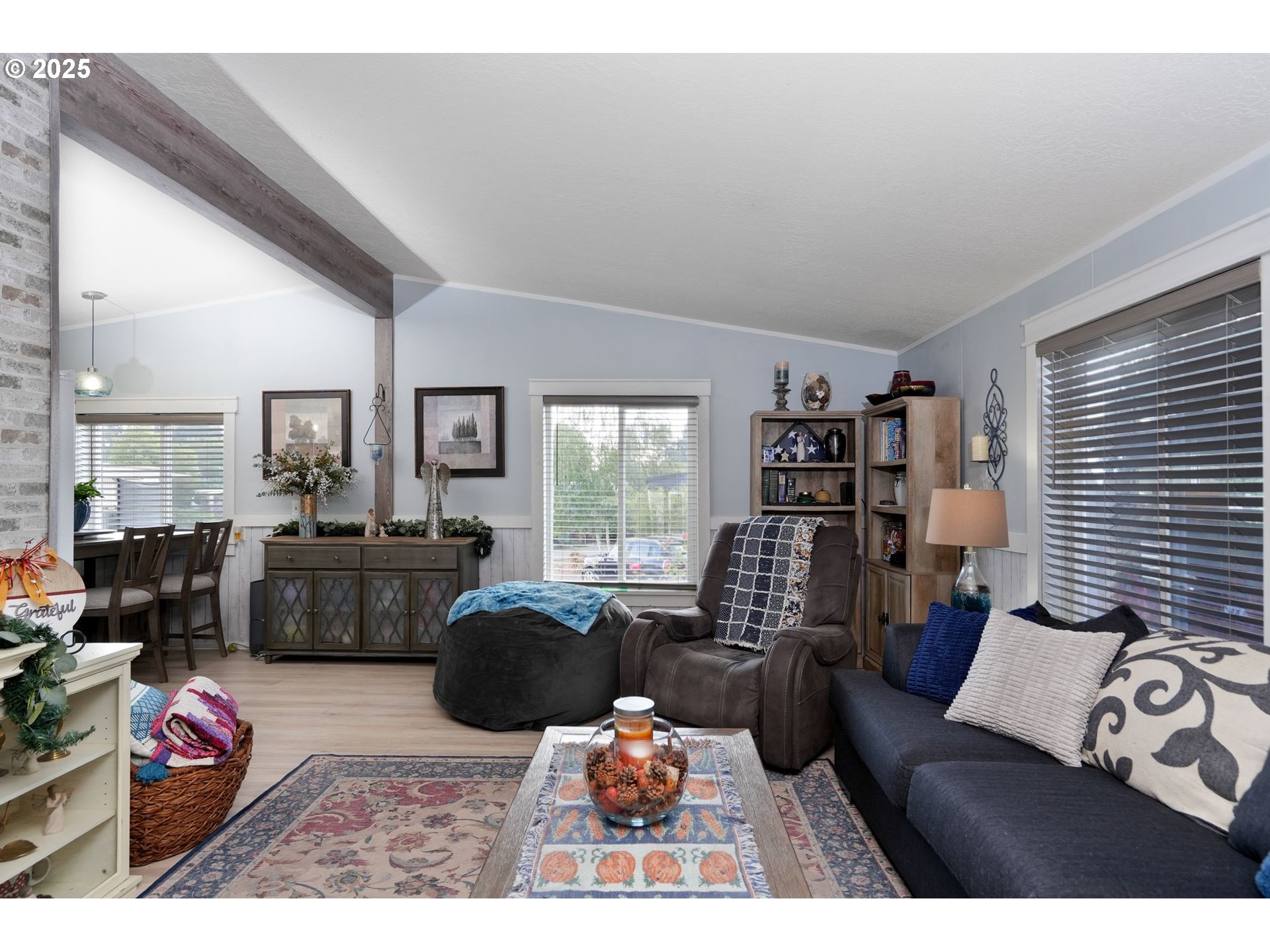 340 Northeast Crest Street, Unit 71 Sublimity, OR 97385 - Photo 12 of 33 a living room with furniture large window and flat screen tv