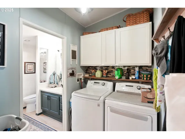 a view of washer and dryer with kitchen countertops