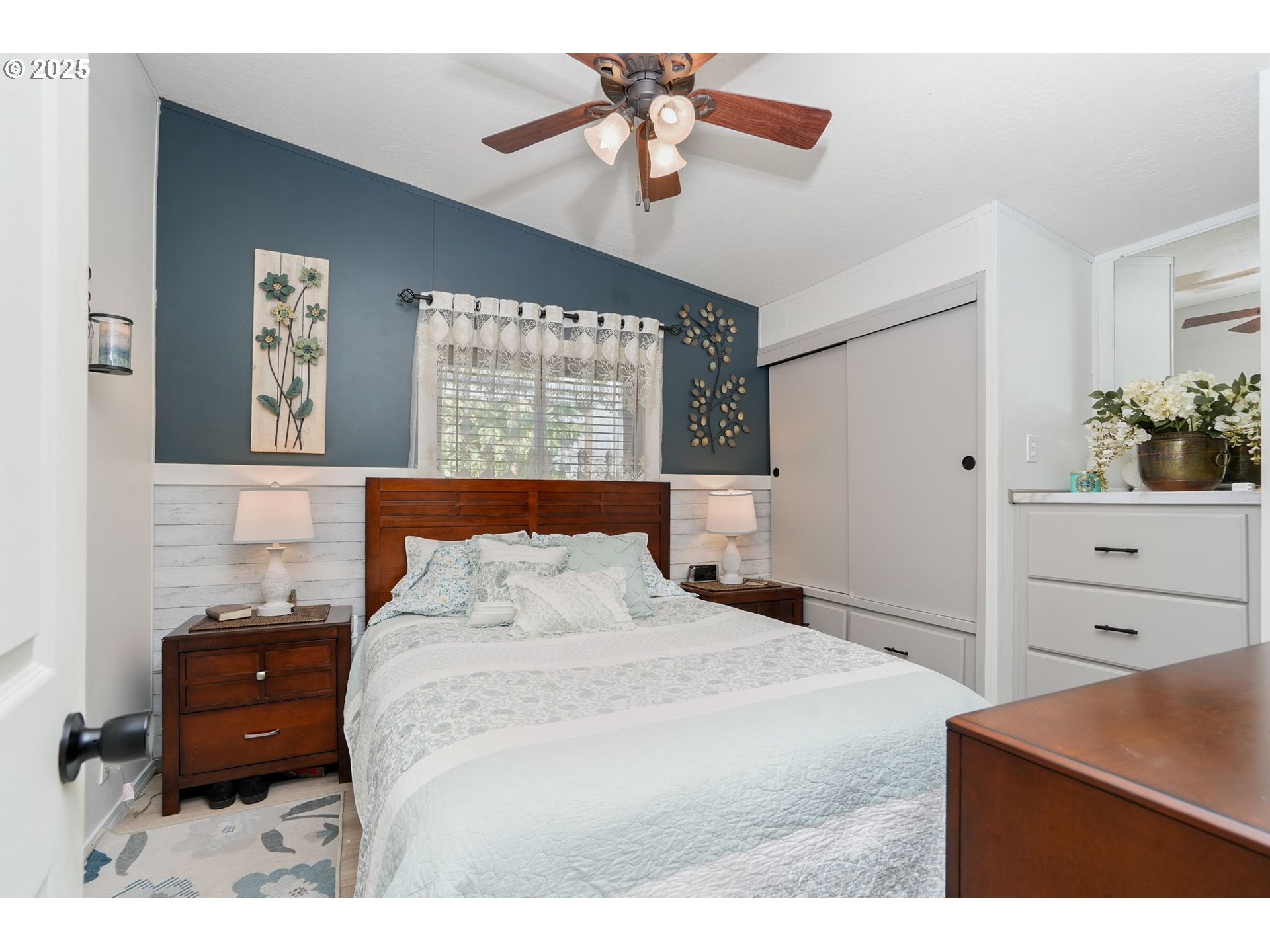 340 Northeast Crest Street, Unit 71 Sublimity, OR 97385 - Photo 19 of 33 a bedroom with a bed and a chandelier