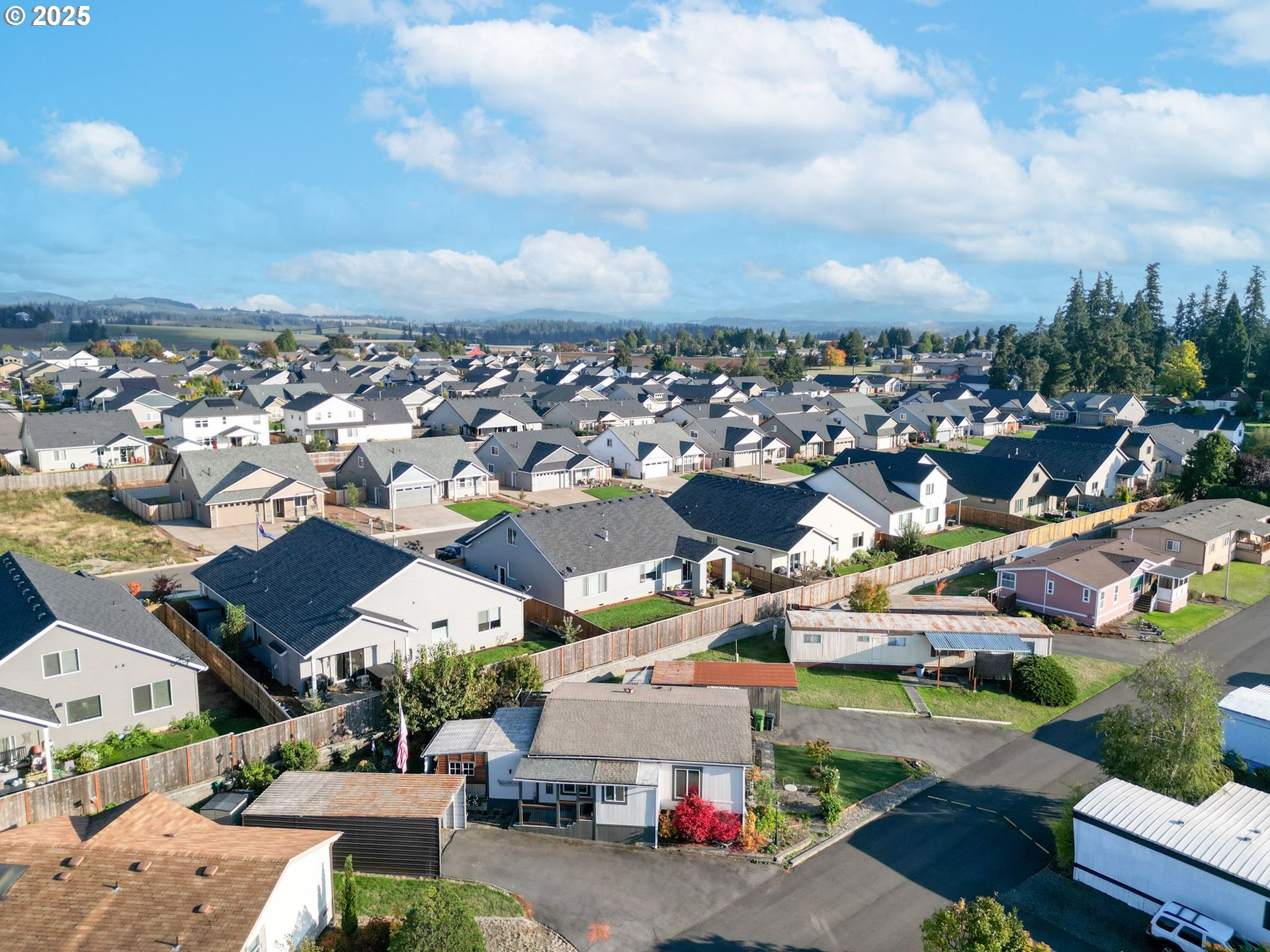 340 Northeast Crest Street, Unit 71 Sublimity, OR 97385 - Photo 2 of 33 an aerial view of a houses with a lot of trees