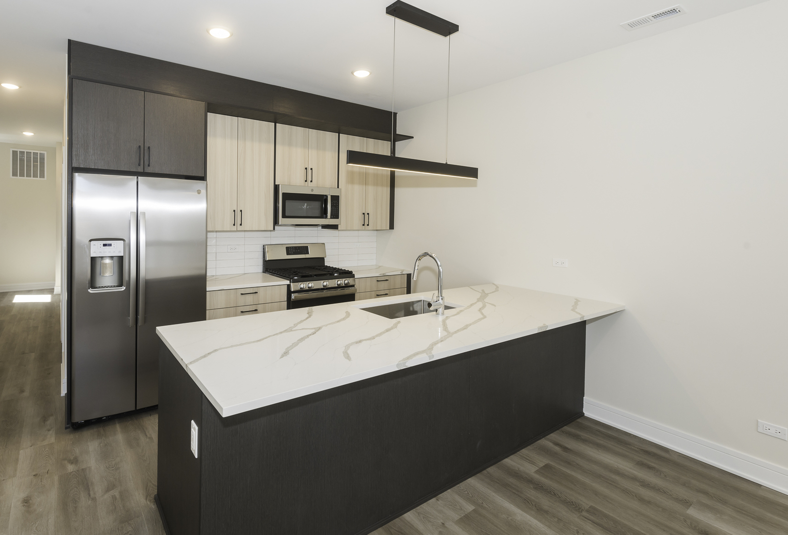 3762 South Indiana Avenue Chicago, IL 60653 - Photo 19 of 27 a kitchen with stainless steel appliances a sink stove and refrigerator