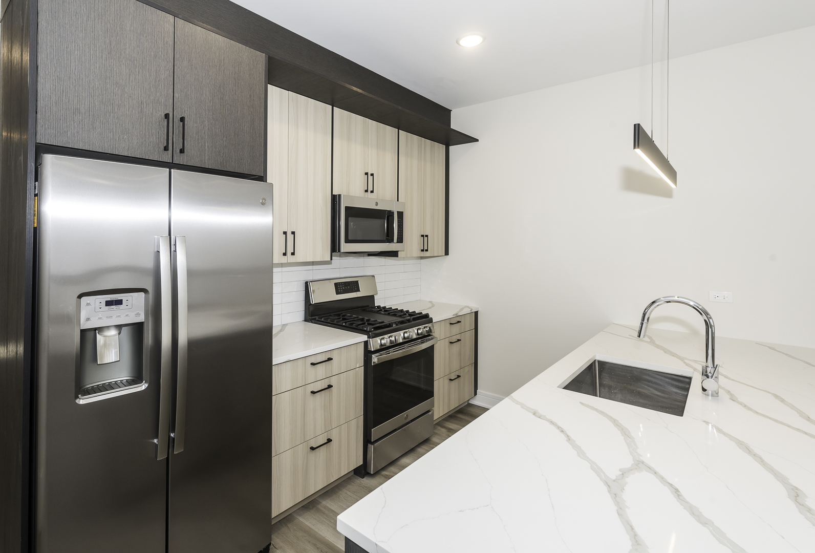 3762 South Indiana Avenue Chicago, IL 60653 - Photo 20 of 27 a kitchen with stainless steel appliances kitchen island a refrigerator sink and microwave