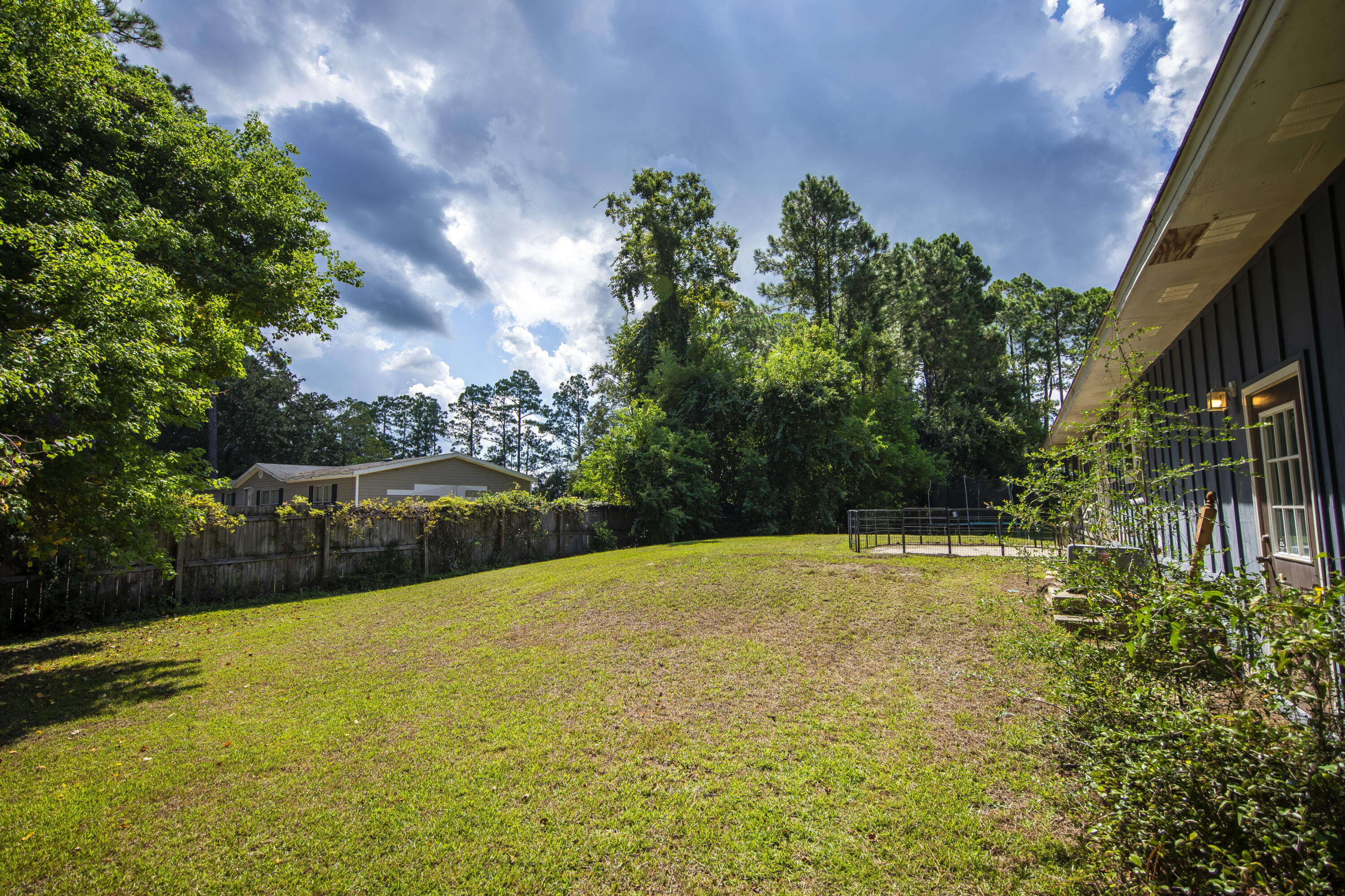 601 Chat Holley Road Santa Rosa Beach, FL 32459 - Photo 23 of 32 a view of a swimming pool with a yard