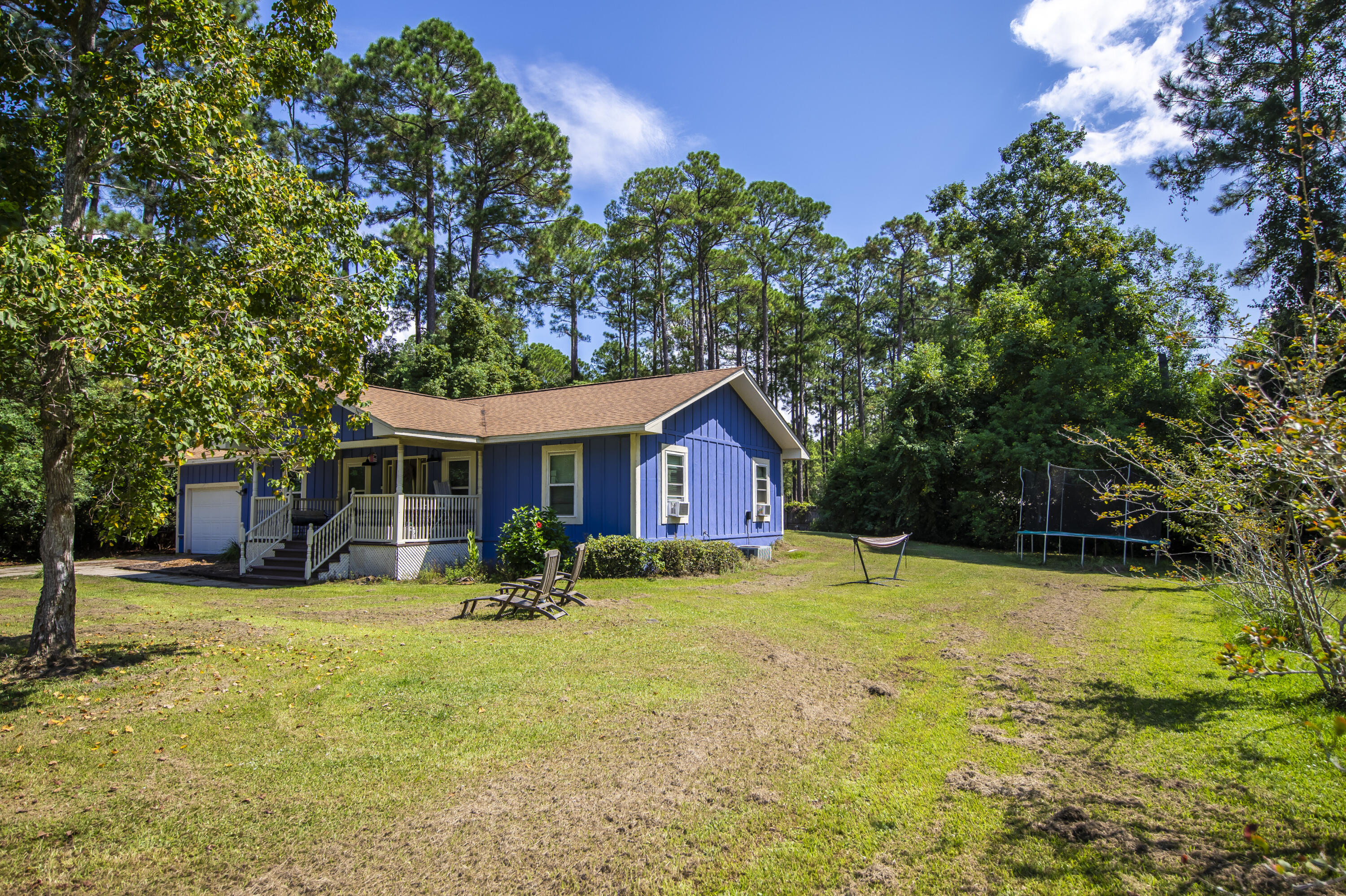 601 Chat Holley Road Santa Rosa Beach, FL 32459 - Photo 25 of 32 a backyard of a house with table and chairs
