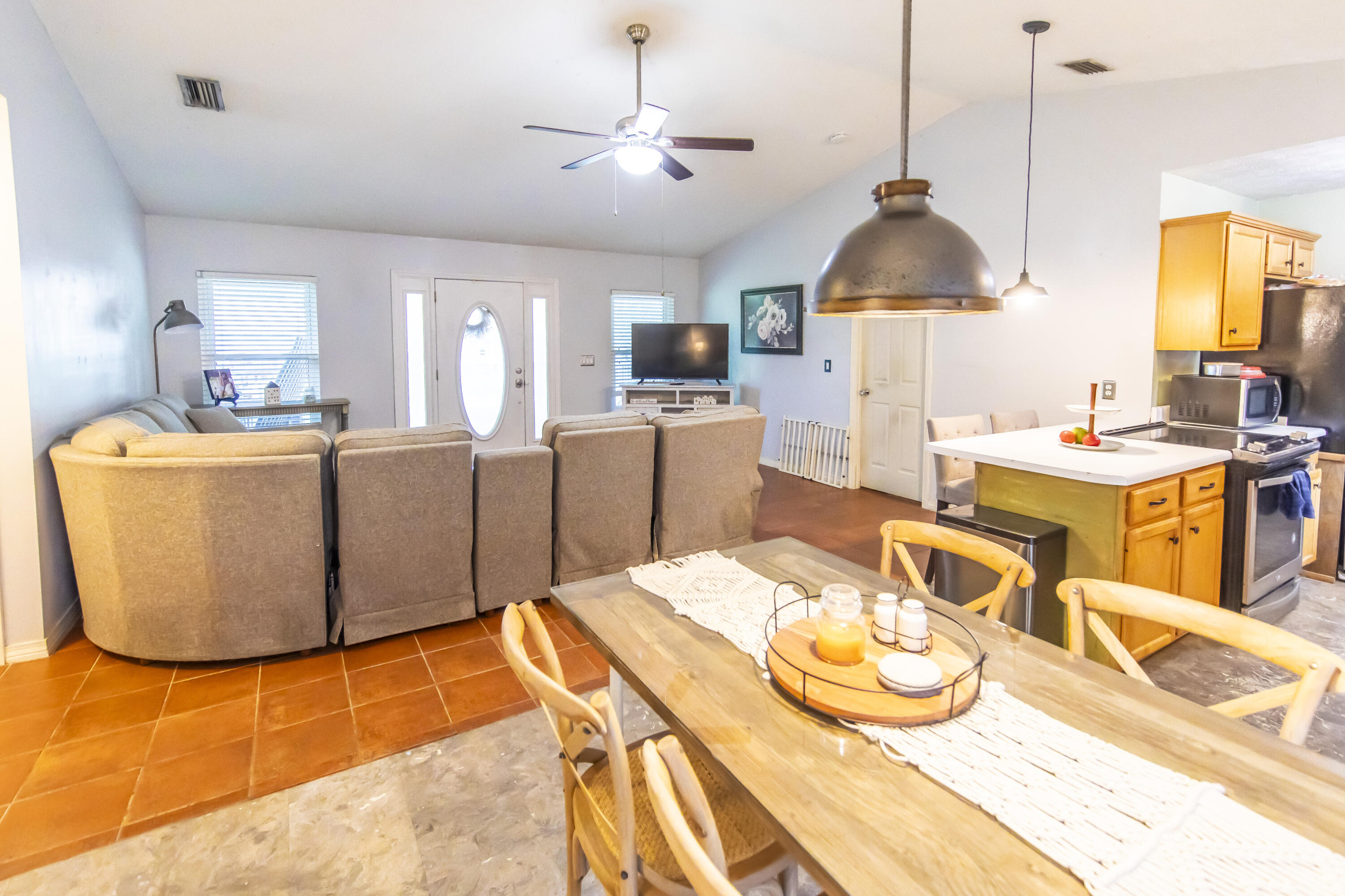 601 Chat Holley Road Santa Rosa Beach, FL 32459 - Photo 5 of 32 a room with stainless steel appliances kitchen island granite countertop a sink a stove and a wooden floors