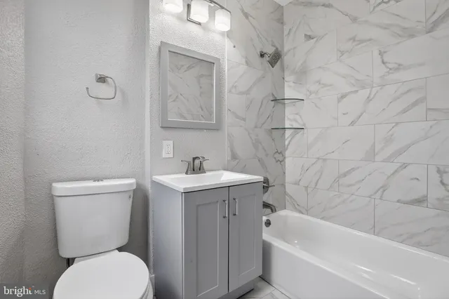 a bathroom with a sink a toilet and bathtub