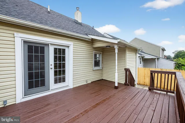 a view of a deck with wooden floor and fence