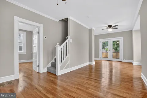 wooden floor in an empty room with a window