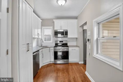 a kitchen with stainless steel appliances granite countertop a stove and a refrigerator