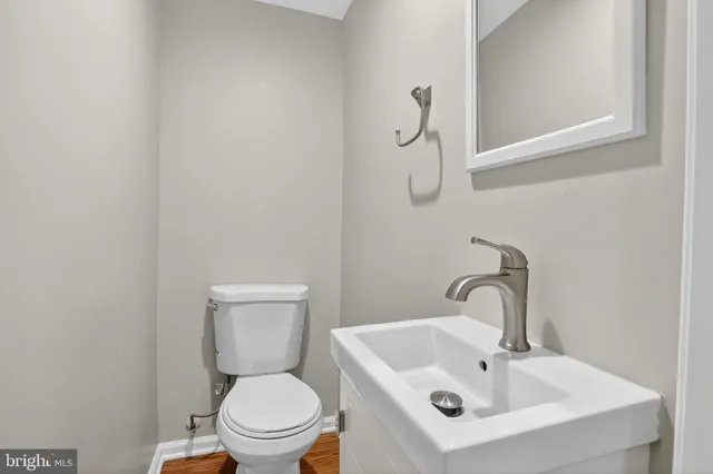 a white toilet sitting next to a bathroom sink