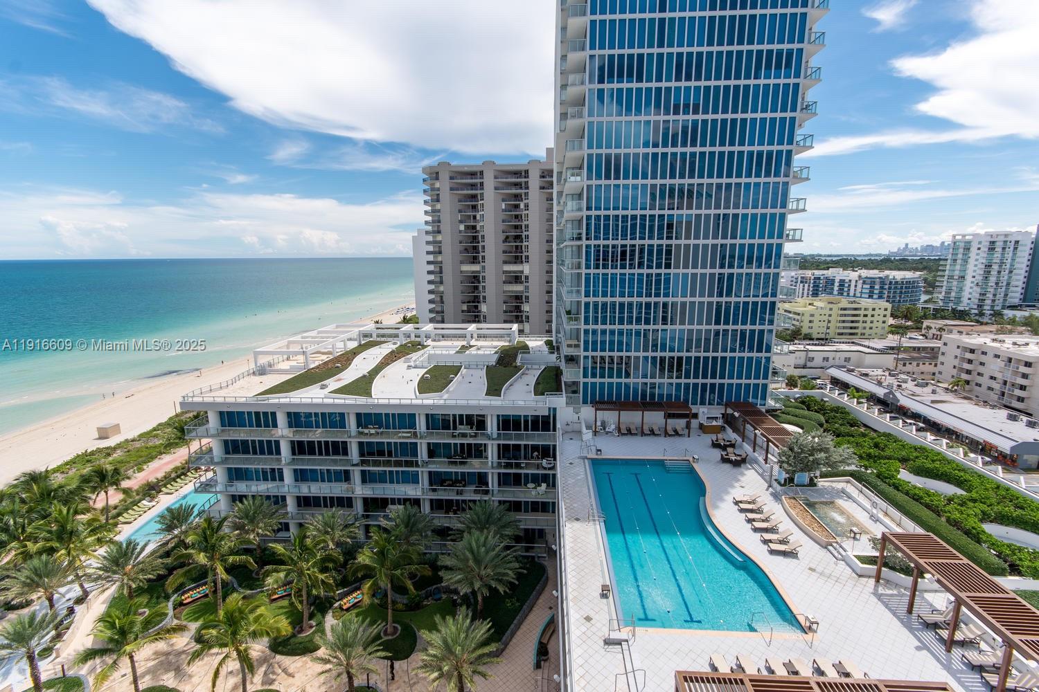 6801 Collins Avenue, Unit PH6 10) Miami Beach, FL 33141 - Photo 1 of 48 a view of a balcony with a floor to ceiling window next to a city