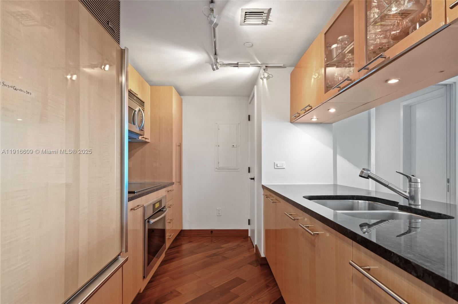 6801 Collins Avenue, Unit PH6 10) Miami Beach, FL 33141 - Photo 12 of 48 a kitchen with granite countertop a sink and cabinets