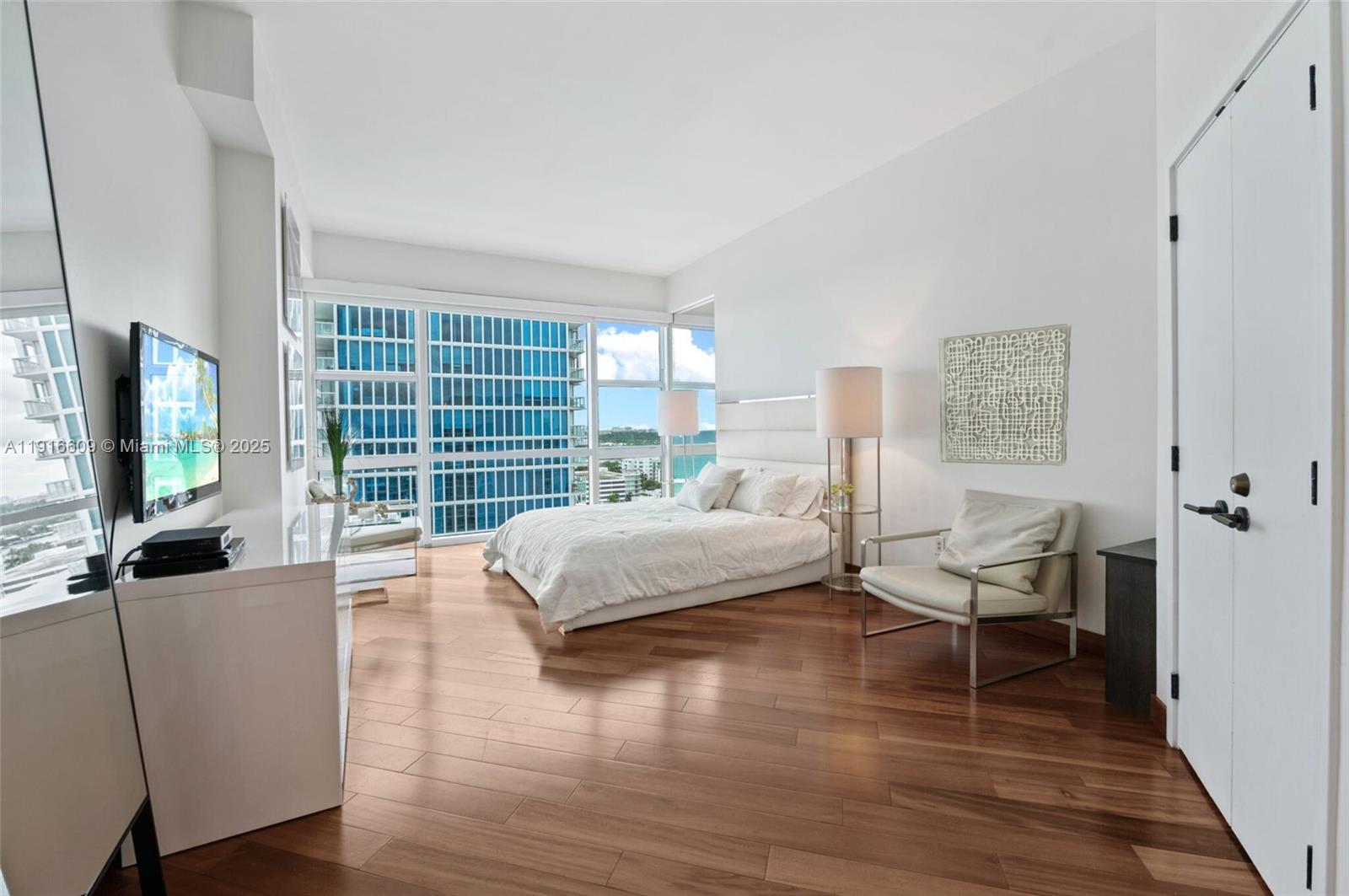 6801 Collins Avenue, Unit PH6 10) Miami Beach, FL 33141 - Photo 17 of 48 a bedroom with a bed and a flat screen television