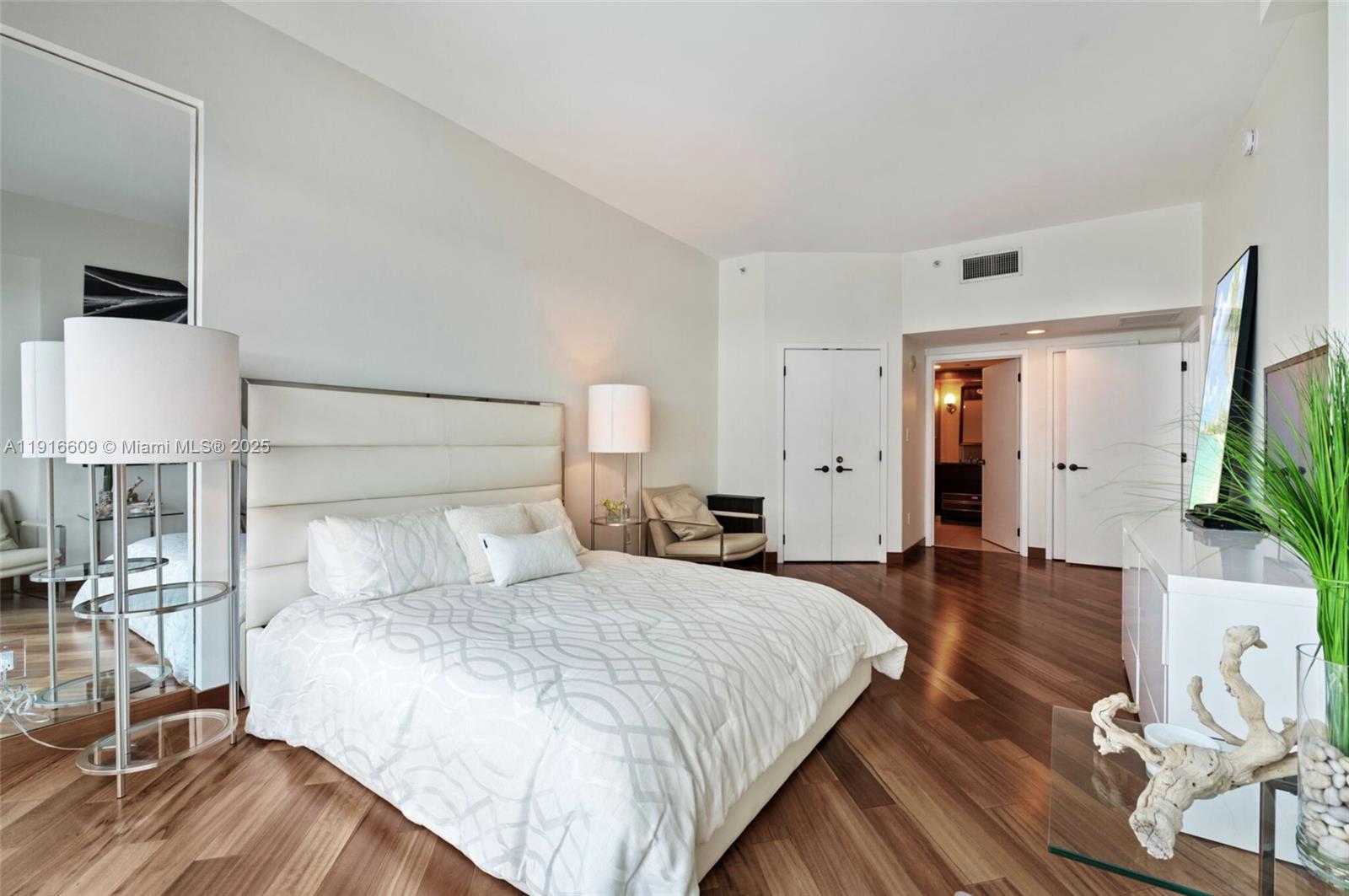 6801 Collins Avenue, Unit PH6 10) Miami Beach, FL 33141 - Photo 18 of 48 a bedroom with a bed and wooden floor