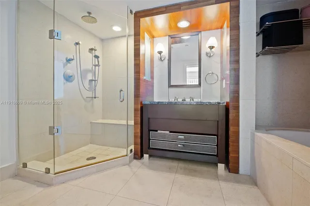 a bathroom with a shower a mirror and a sink