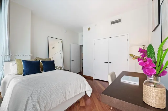 a bedroom with a bed dresser and a window