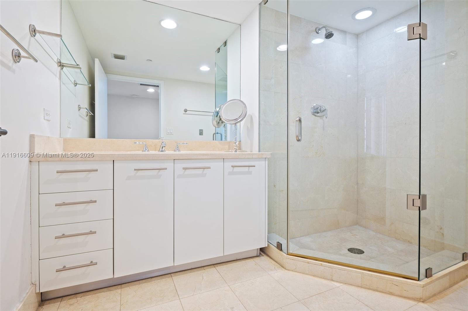 6801 Collins Avenue, Unit PH6 10) Miami Beach, FL 33141 - Photo 29 of 48 a bathroom with a shower sink and mirror