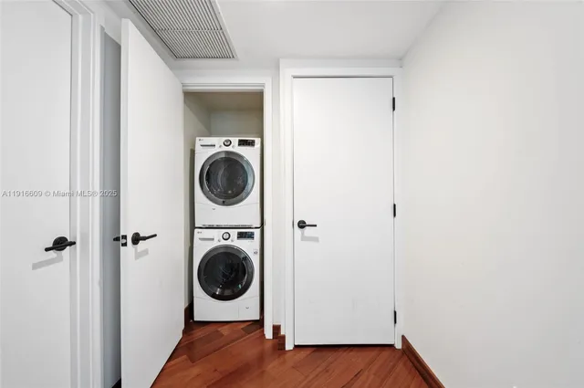 a small space with wooden floor and a sink
