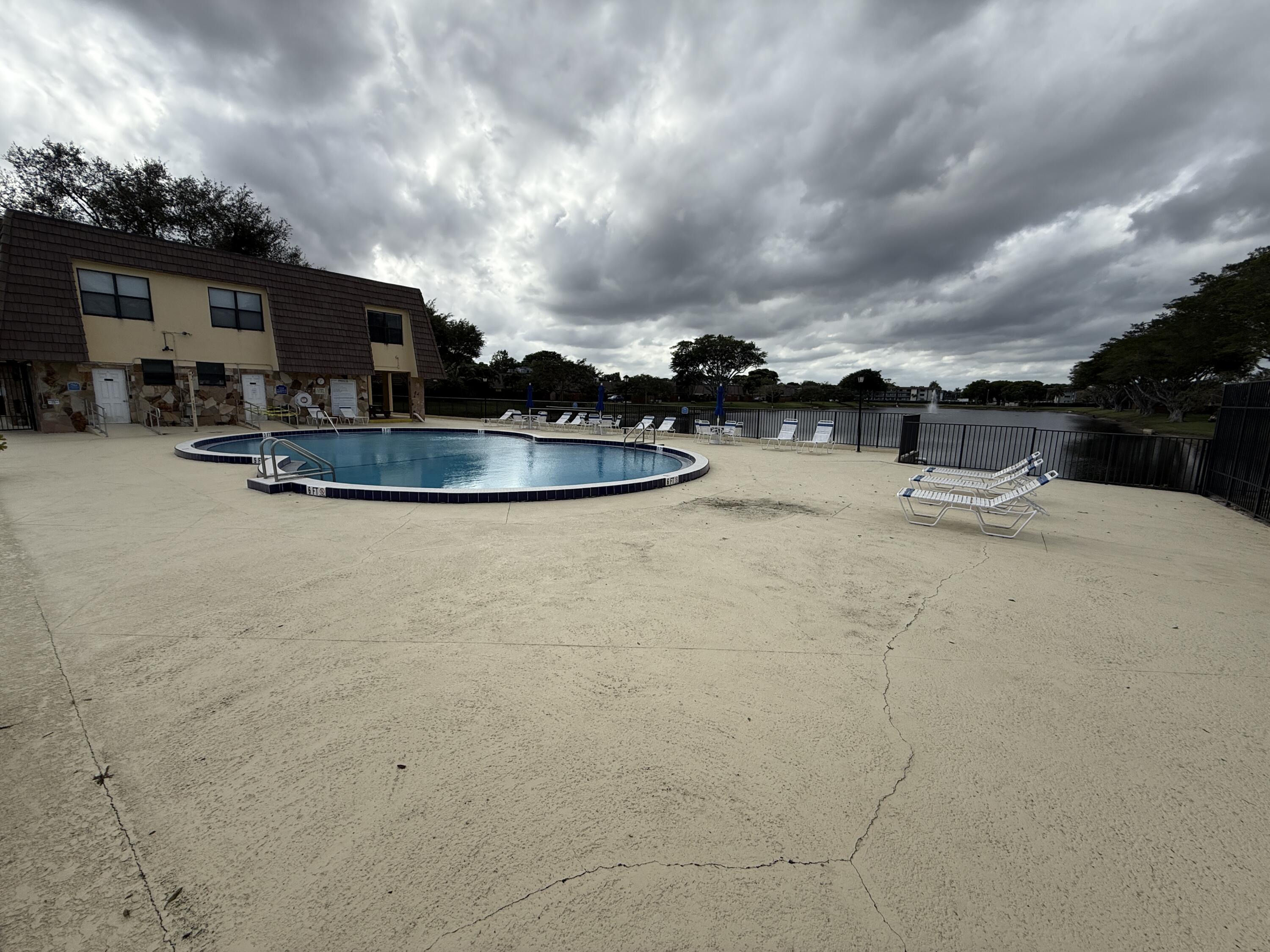 1021 Springdale Circle Palm Springs, FL 33461 - Photo 30 of 32 30 - Clubhouse Pool Deck