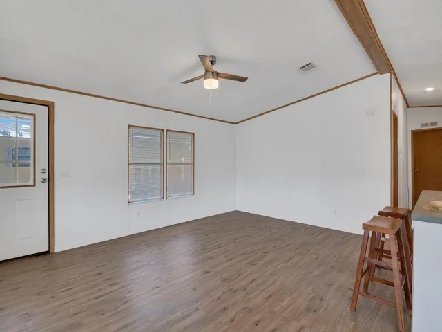 a kitchen with granite countertop a refrigerator and a stove top oven