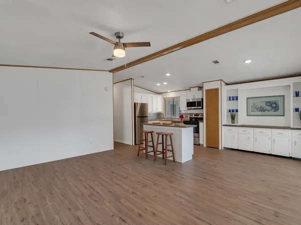 a kitchen with kitchen island wooden cabinets and stainless steel appliances