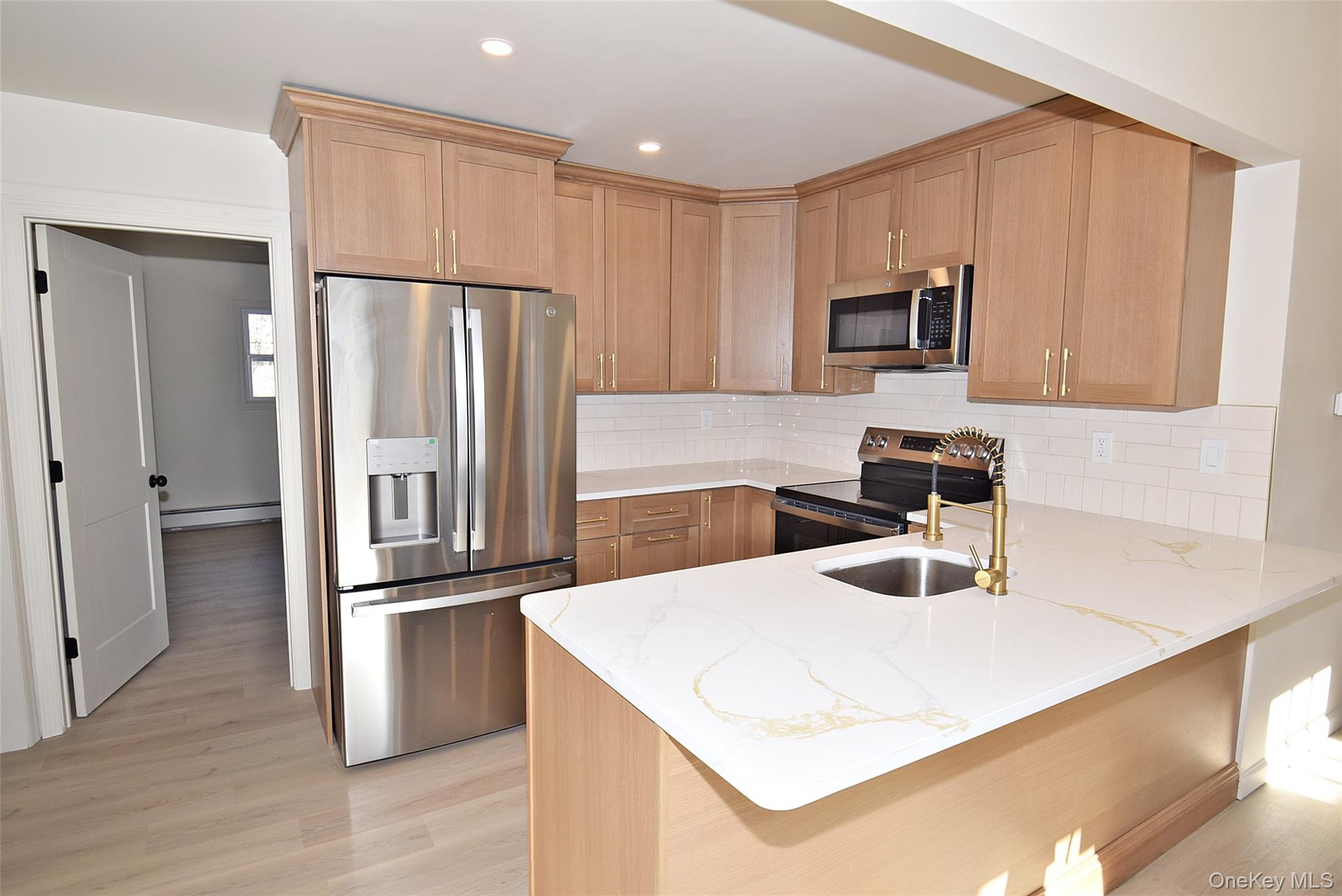 371 Oceanside Street Islip Terrace, NY 11752 - Photo 11 of 38 a kitchen with granite countertop a refrigerator and a sink