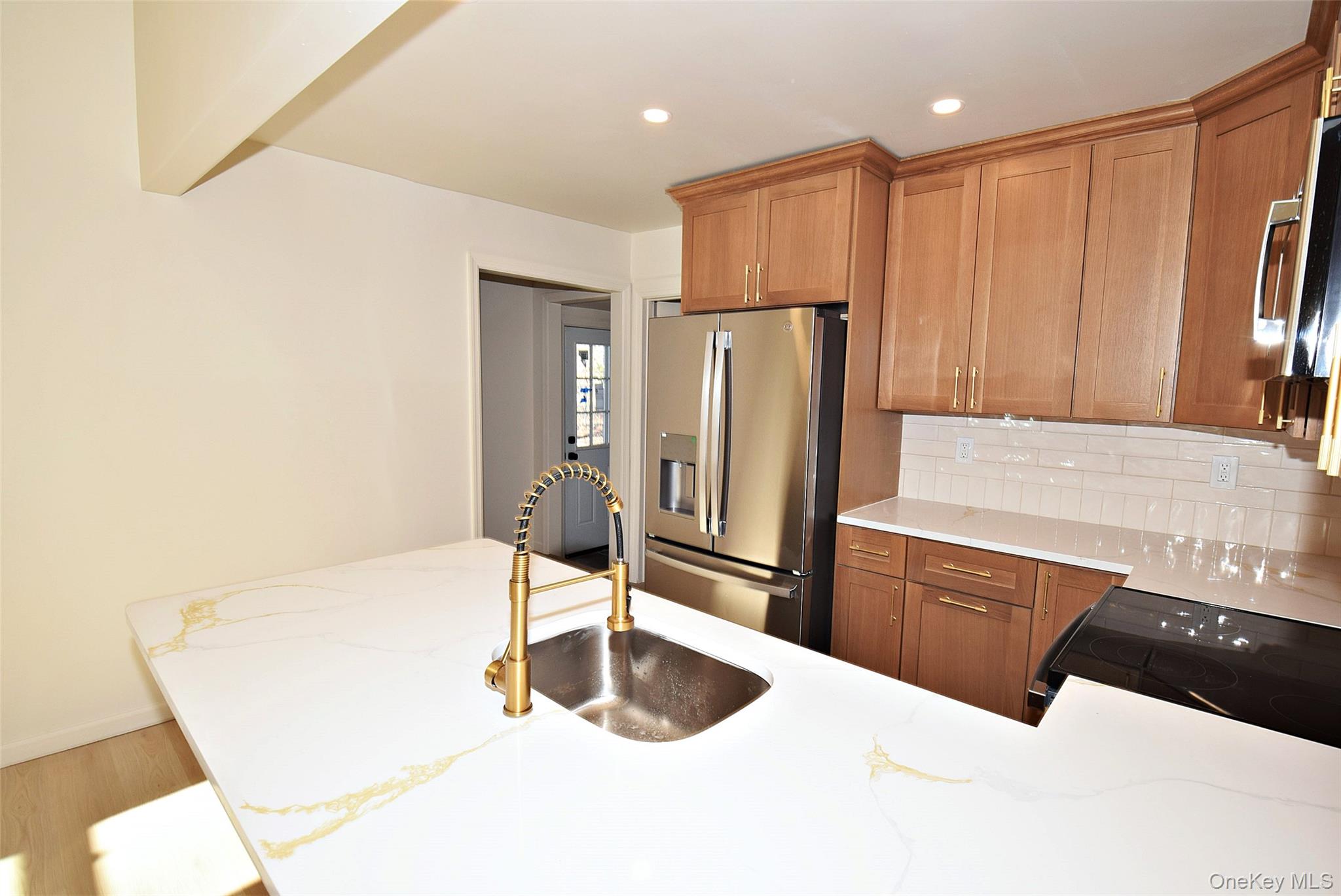 371 Oceanside Street Islip Terrace, NY 11752 - Photo 14 of 38 a kitchen with stainless steel appliances a refrigerator and a counter top space