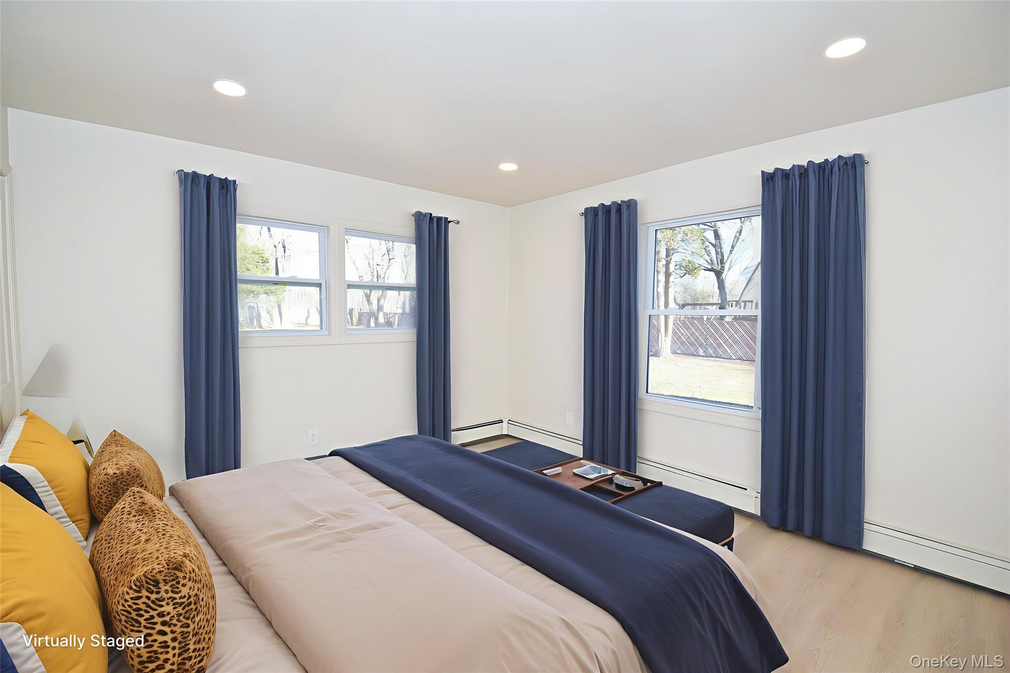 371 Oceanside Street Islip Terrace, NY 11752 - Photo 15 of 38 a bedroom with a bed and a window