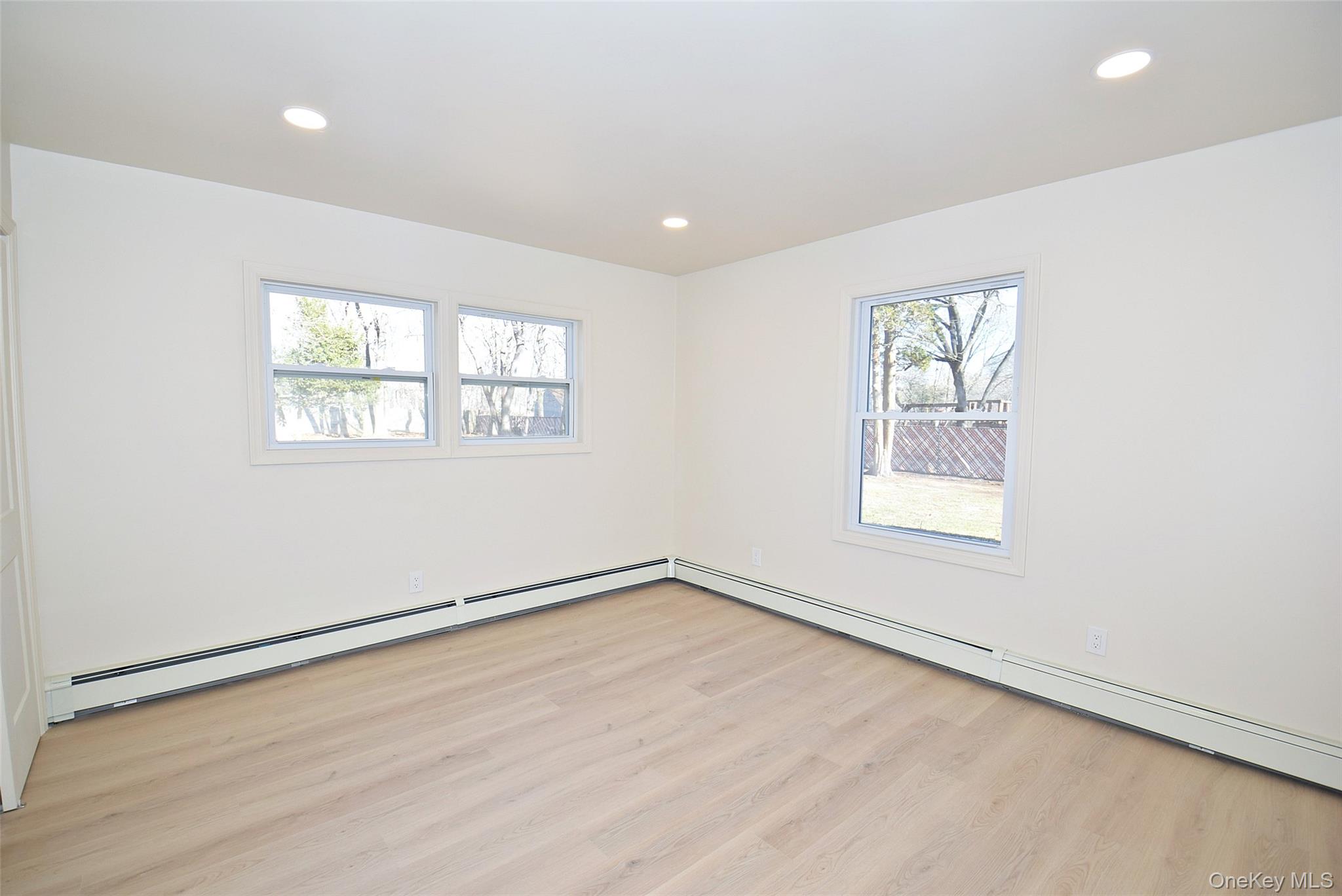 371 Oceanside Street Islip Terrace, NY 11752 - Photo 16 of 38 an empty room with windows