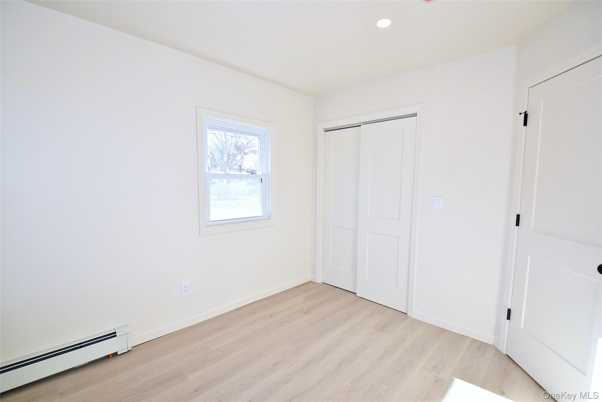 371 Oceanside Street Islip Terrace, NY 11752 - Photo 21 of 38 wooden floor in an empty room