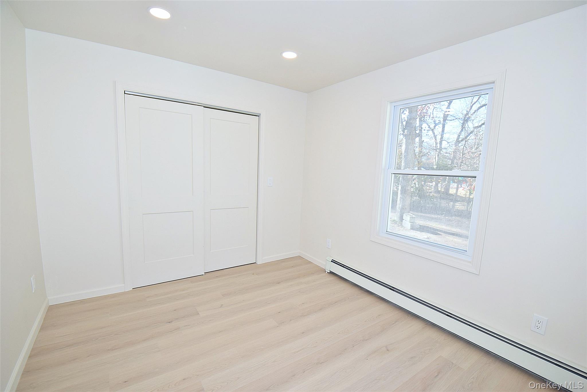 371 Oceanside Street Islip Terrace, NY 11752 - Photo 26 of 38 an empty room with windows