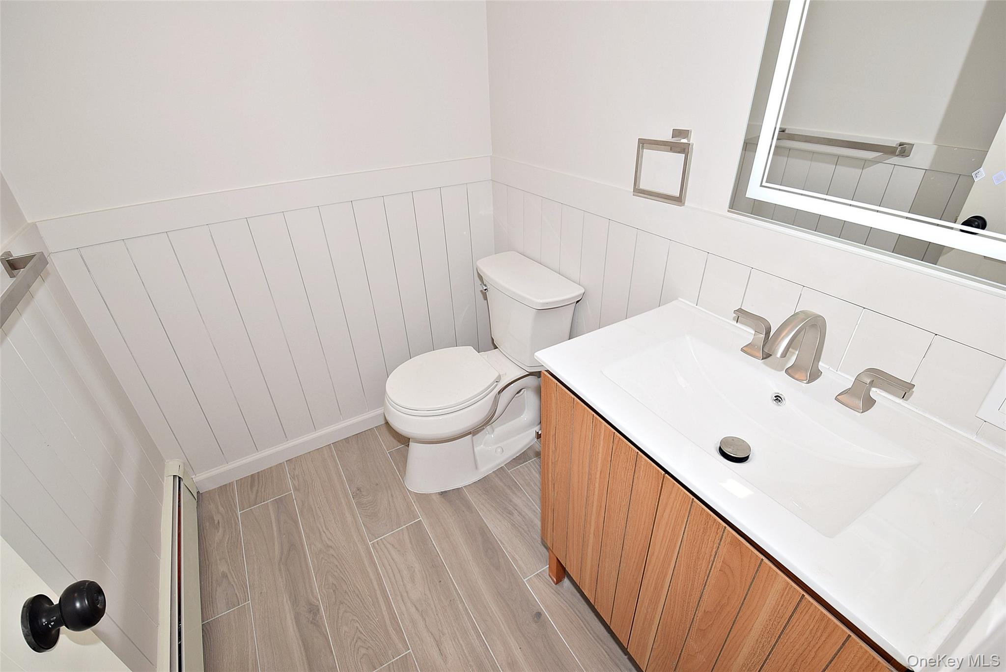371 Oceanside Street Islip Terrace, NY 11752 - Photo 29 of 38 a bathroom with a sink and a mirror