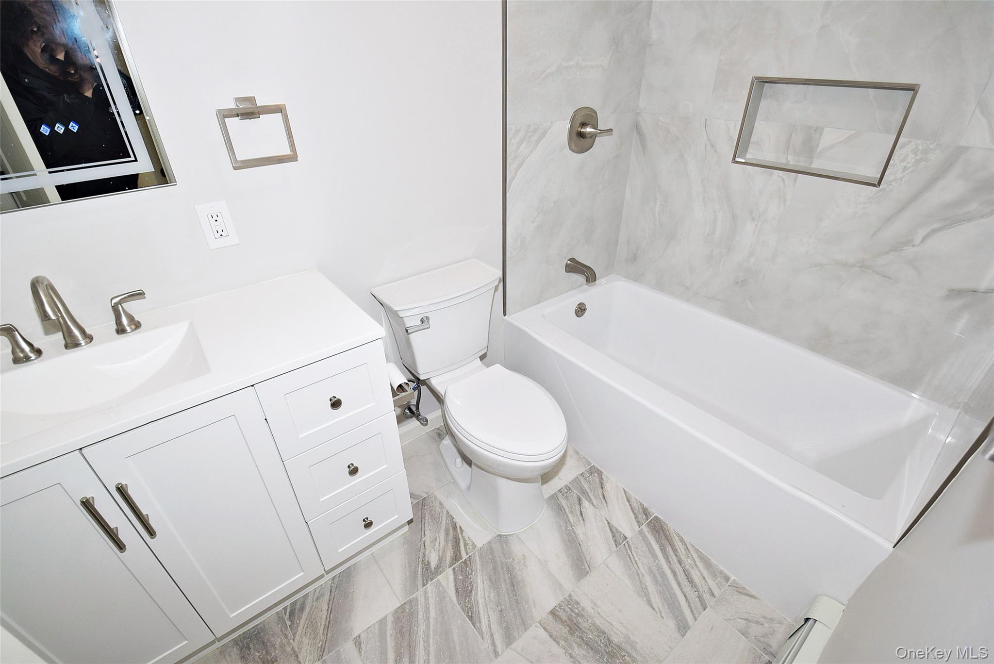 371 Oceanside Street Islip Terrace, NY 11752 - Photo 30 of 38 a white toilet sitting next to a bathroom sink