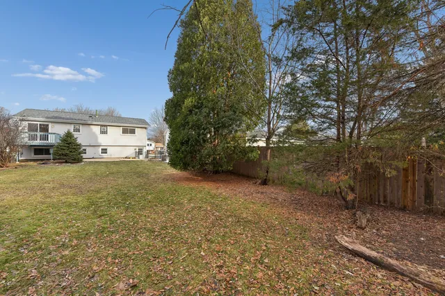 a view of a house with a yard and garage