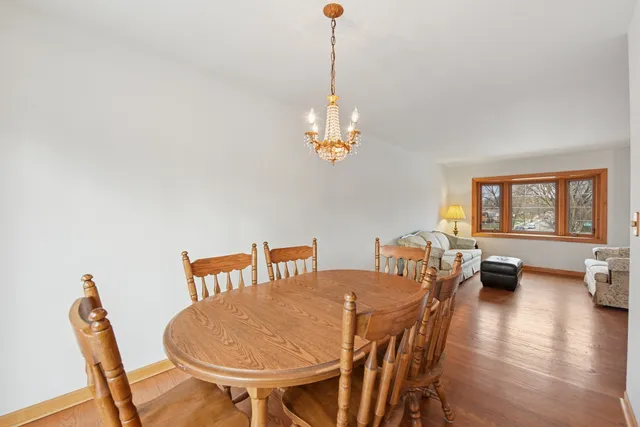 a view of a dining room with furniture wooden floor and a chandelier