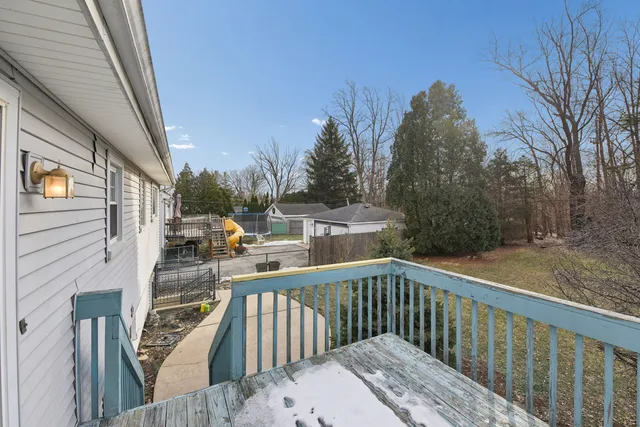 a view of a balcony with yard