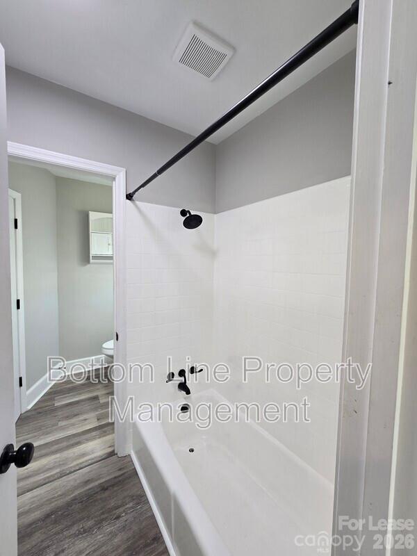 5949 Quail Hollow Road, Unit D Charlotte, NC 28210 - Photo 30 of 34 a bathroom with a bathtub and a shower