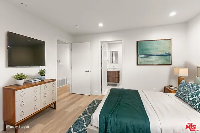 a bedroom with a bed and a flat screen tv