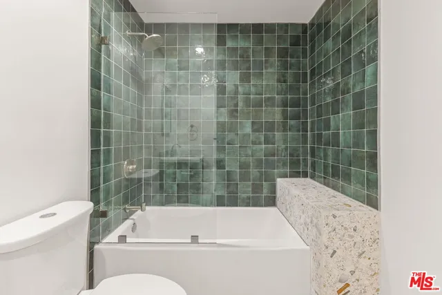 a bathroom with a bathtub and a toilet