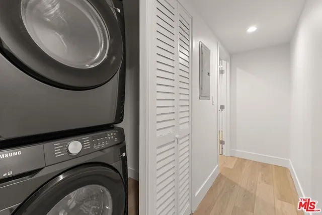 a view of a hallway with washer and dryer