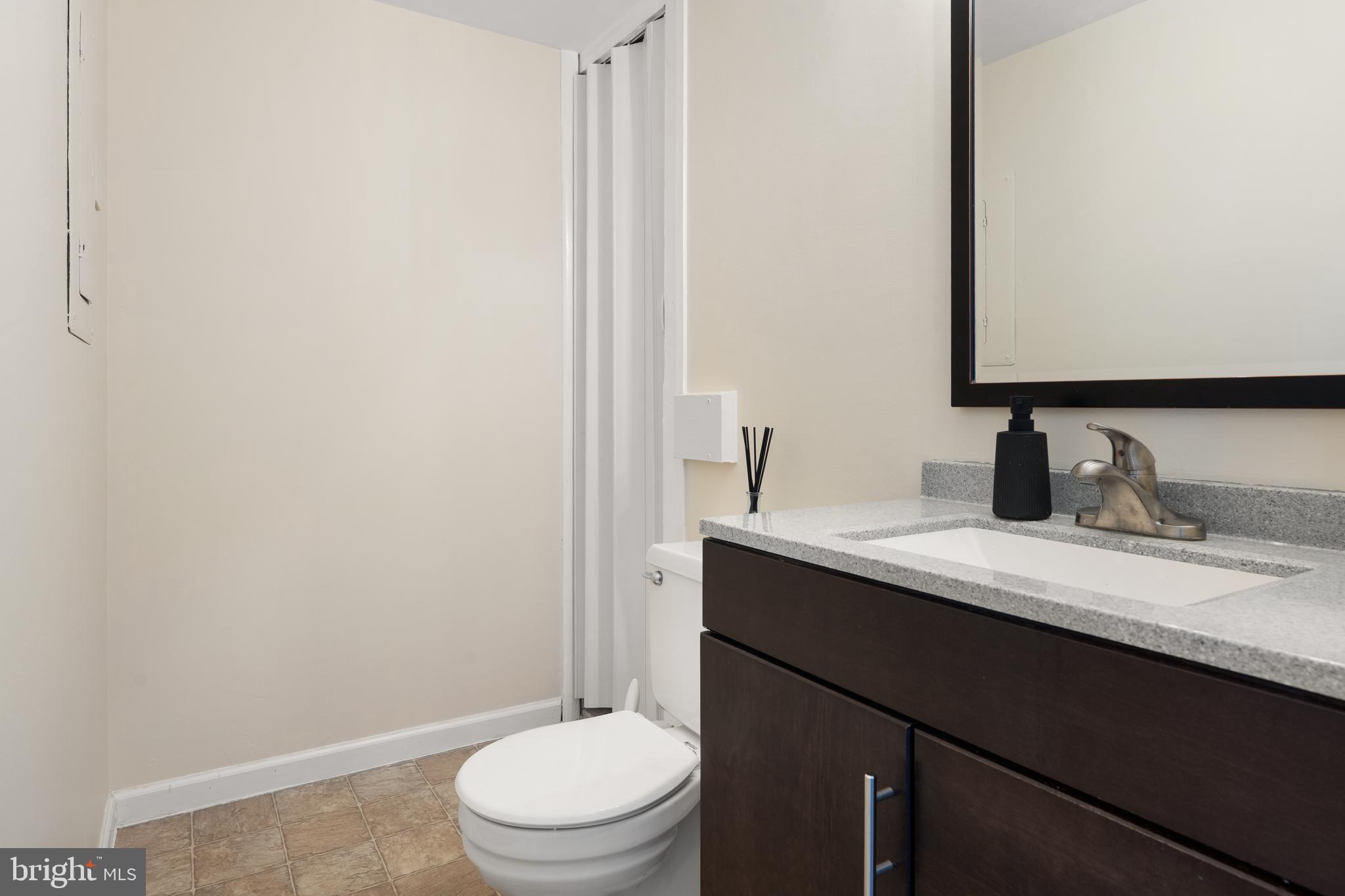 18 Wenner Drive Brunswick, MD 21716 - Photo 10 of 30 a bathroom with a granite countertop sink toilet and mirror